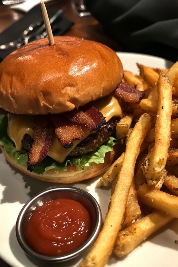 Gourmet burger with crispy bacon and fries