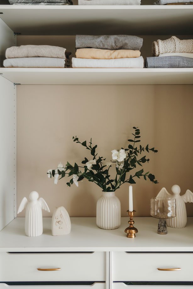 Closet with angel figurines and soft lighting