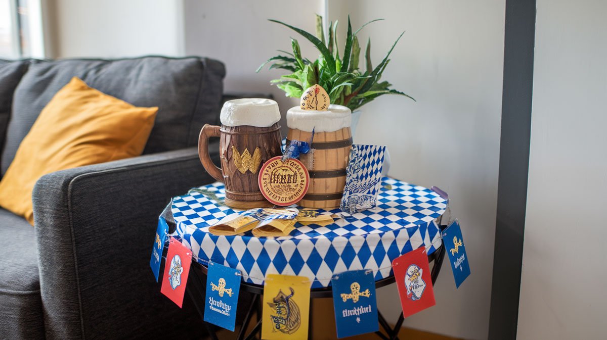 Table with stein-holding props and Oktoberfest trivia cards.